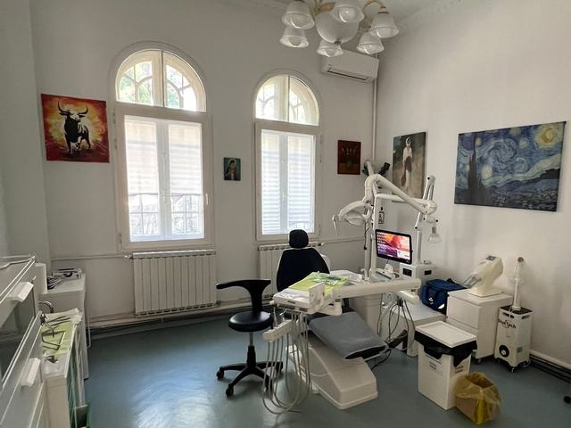 Cabinet dentar spațios la DentalClinica, cu două ferestre în arc, unit dentar și monitor